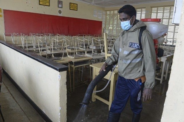 CLEAN. A policeman sprays disinfectant in a classroom at the Anula school, in the suburb of Nugegoda in Colombo on June 19, 2020. Photo by Lakruwan Wanniarachchi/AFP 