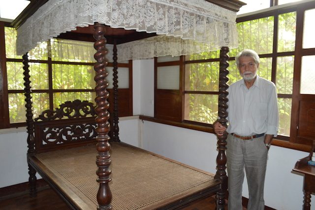 George Aseniero standing beside Rizal's old bed, which the national hero left to the Asenieros. Photo by Gualberto Laput 