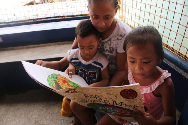 THE READER. Bianca reads with her mother and brother. Children are encouraged to start reading at an early age to prepare them for lifelong learning. Photo by Ella Carino/Save the Children  