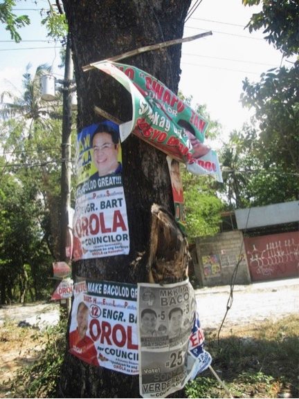 NAILED ON TREES. Campaign paraphernalia materials are nailed on trees along the streets of Bacolod City. Photo by Claudia Gangayco   