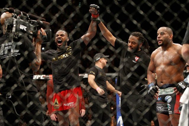 Jon Jones (L) celebrates after defeating Daniel Comier (R) during their light heavyweight title fight. Jones retained his title by unanimous decison. Steve Marcus/AFP