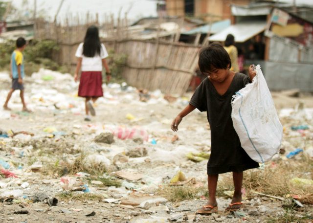 CHILD LABOR. A Filipino boy works by collecting useful materials at a slum area in Manila. File photo by Francis Malasig/EPA 