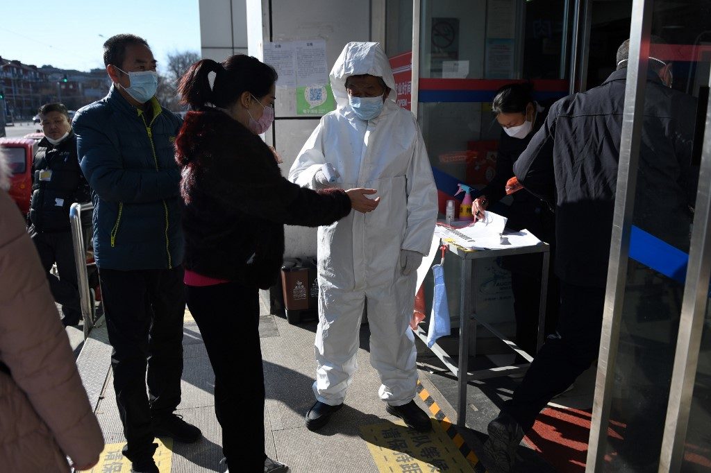 New normal in virus-hit China: High-tech tracking and fever checks