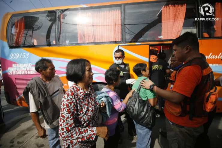 SAFE. Passengers are escorted by local authorities for for medical assessment and additional interviews. Photo by Ben Nabong/Rappler

