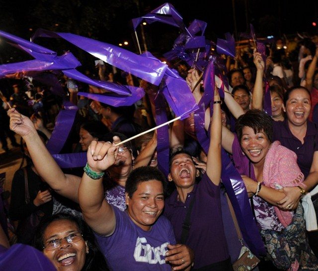 HISTORIC LAW. Supporters of the Reproductive Health law celebrate its passage in December 2012 after over a decade of debates in Congress. File photo by Jay Directo/AFP 