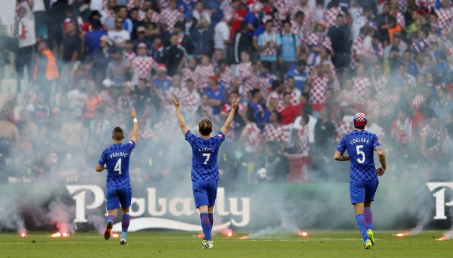 APPEAL. Croatia players (L-R) Ivan Perisic, Ivan Rakitic and Vedran Corluka appeal to Croatia supporters (background) after flares were thrown onto the pitch during the UEFA EURO 2016 group D preliminary round match between the Czech Republic and Croatia. Photo by YURI KOCHETKOV/EPA 