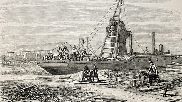 CONSTRUCTION. Old illustration of a dredger in Port Said, working in Suez canal excavation. Original, from drawing of Blanchard and Anastasi, was published on L'Illustration, Journal Universel, Paris, 1860. Shutterstock.com 