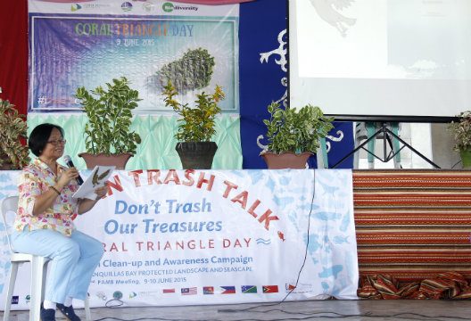 INTERCONNECTED. Bureau of Fisheries and Aquatic Resources Project Management Office Director Jessica Muñoz reads aloud a story emphasizing interdependence between humans, wildlife, and the environment, during the Coral Triangle Day celebration in Margosatubig. Image courtesy of Patrie Cianne Gelvezon / DENR-BMB  