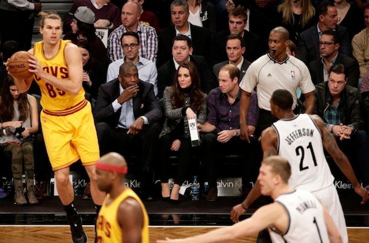Britain's Duke and Duchess of Cambridge, Prince William (C-R) and Catherine (C-L) share popcorn next to for NBA player Dikembe Mutombo (L) during the Cleveland Cavaliers vs Brooklyn Nets, NBA game at the Barclays Center in Brooklyn, New York, USA, 08 December 2014. Jason Szenes/EPA