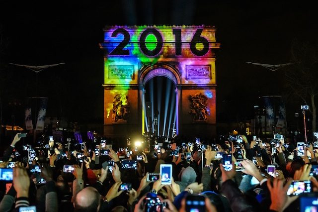 Defiant Parisians throng Champs-Elysees to bid adieu to 2015