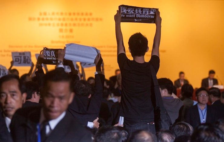 'WE WANT DEMOCRACY' Pro-democracy protesters disrupt a speech by Li Fei, Deputy Secretary-General of the Standing Committee of the National People's Congress (NPCSC) of the People's Republic of China at a briefing session on constitutional development, in Hong Kong, China, 01 September 2014. Alex Hofford/EPA