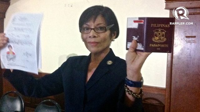 EVIDENCE. Regina Reyes shows evidence that will prove she's a natural-born Filipino. File photo by Ace Tamayo  