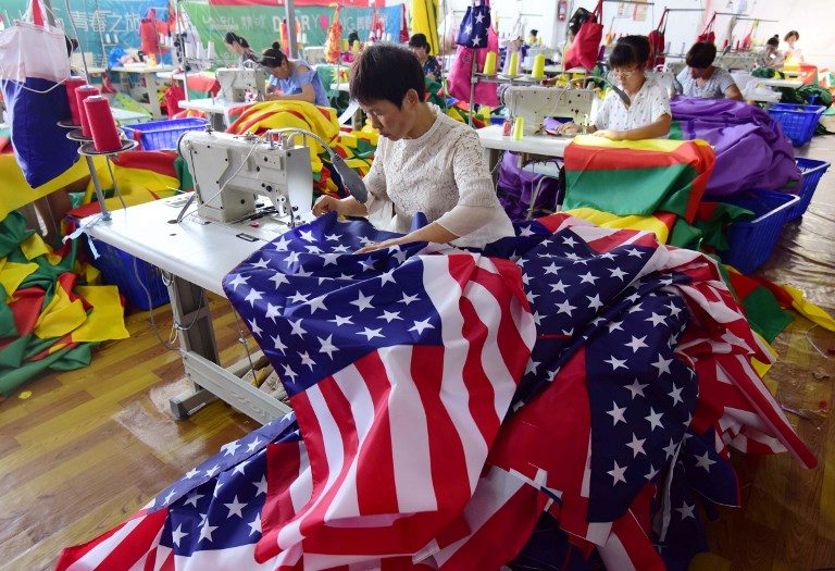 As trade war rages, Trump flags fly out of China factory