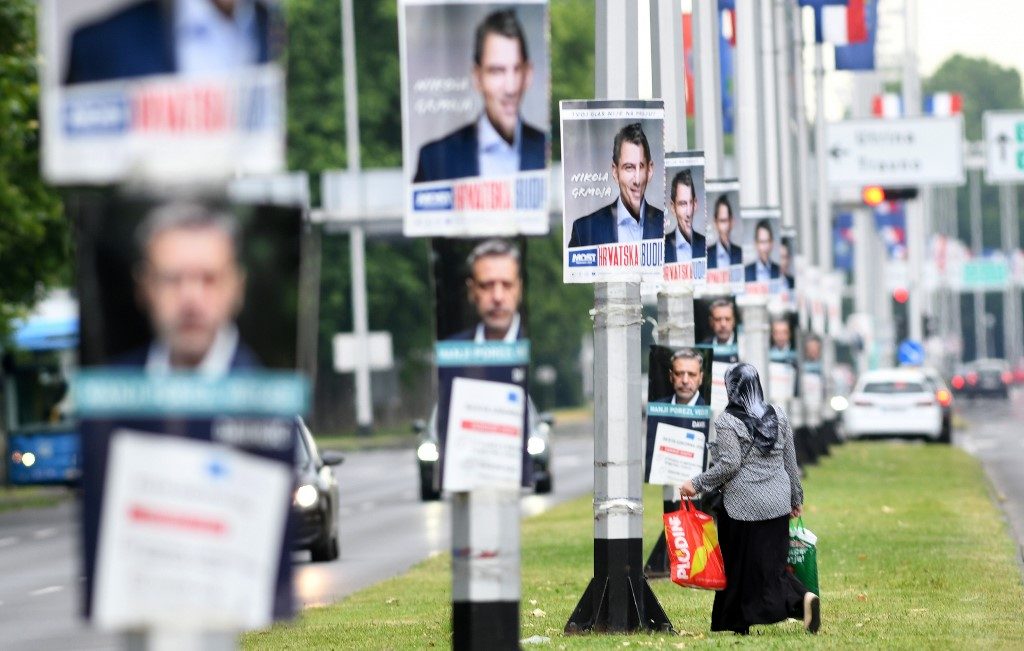 CAMPAIGN POSTERS. A woman walks by campaign posters in Zagreb on July 2, 2020 ahead of the parliamentary election of July 5. Photo by Denis Lovrovic/AFP 