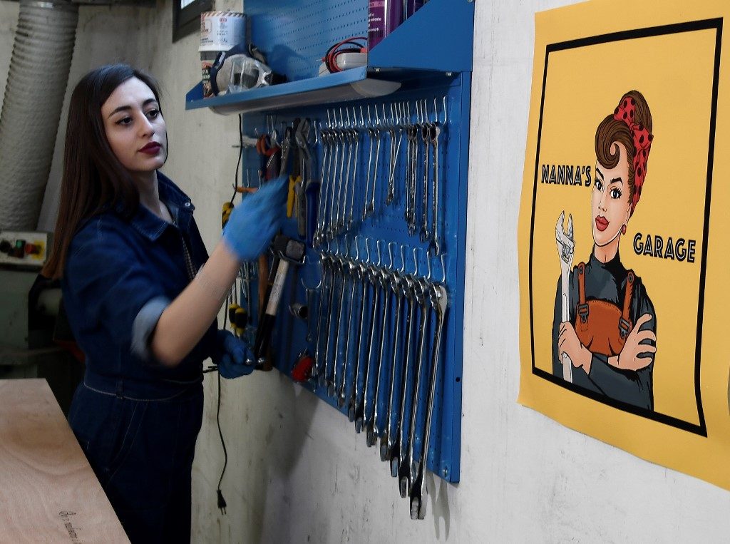 NANNA'S GARAGE. In the co-working spaces of a former night train maintenance factory in Rome, Officine Zero (Oz), Giovanna found a place to carry on her hobby and continue her adventure in the world of classic car restoration. Photo by
Filippo Monteforte/AFP
   