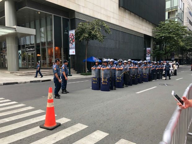 GUARDED. Police in riot gear surround nearby streets during Chinese President Xi Jinping's state visit.  