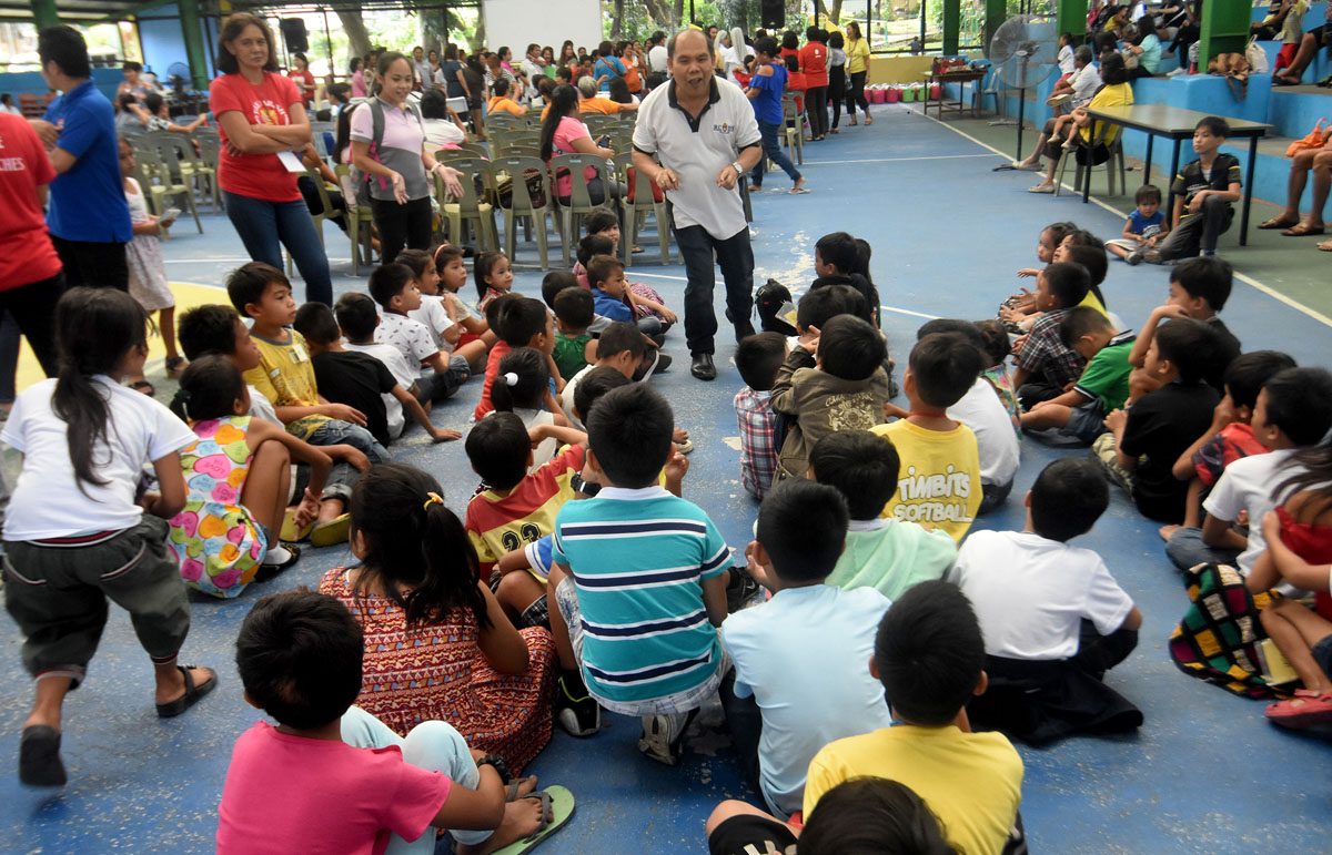 STORYTELLING. Kids of EJK families' victims listening attentively to some volunteers of the Diocese of Novaliches. Photo by Angie de Silva/Rappler 
