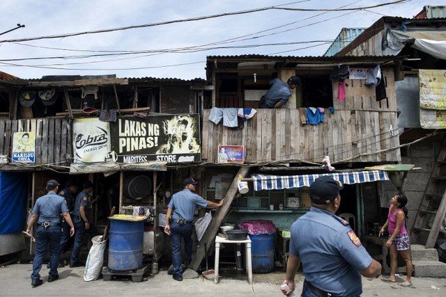 TOKHANG. Police implement Oplan TokHang, a literal door-to-door knock-and-plead operation that targets suspected drug users and pushers. It aims to curb demand. File photo by Noel Celis/AFP    