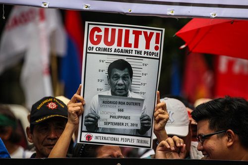 PROTESTS PUSH THROUGH. For the Martial Law anniversary on September 21, 2018, activist groups carry a photo of President Rodrigo Duterte, whom the International People's Tribunal declared guilty of crimes against humanity. Photo by Maria Tan/Rappler  