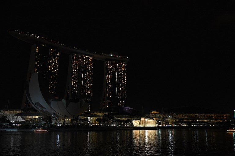 SINGAPORE. A general view shows Marina Bay Sands hotel and resort with the lights switched off during the Earth Hour environmental campaign in Singapore on March 24, 2018. Photo by Roslan Rahman/AFP 