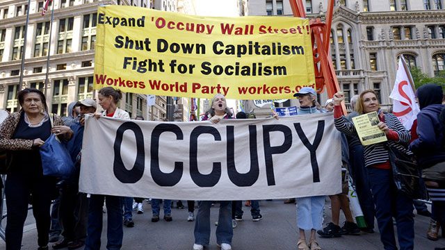 Protesters carry a banner during a march to mark the two year anniversary of the Occupy Wall Street movement in New York, New York, USA, 17 September 2013. The grass roots movement against fiscal inequity and government policies began in New York in 2011 and sparked similar movements in cities across the USA and other countries. EPA/JUSTIN LANE