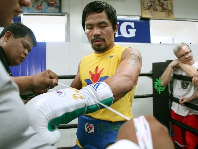 Manny Pacquiao gets laced up for training. Photo by Chris Farina - Top Rank 