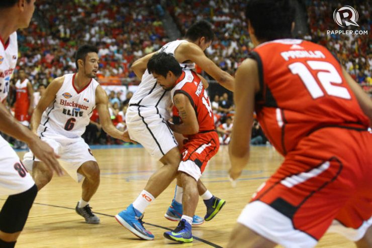 Manny Pacquiao struggles with an opposing player after losing control of his dribble. Photo by Josh Albelda
