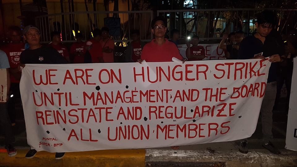 HUNGER STRIKE. Workers hold a banner outside Pacific Plaza Towers where they are conducting a hunger strike. Photo from SUPER-BMP  