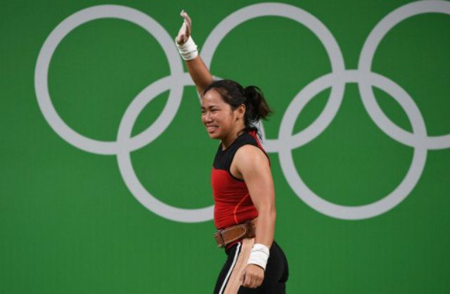 SILVER SMILE. Hidilyn Diaz waves and smiles after a successful lift. She was the first Filipina to earn an Olympic medal. Photo by Goh Chai Hin/AFP 