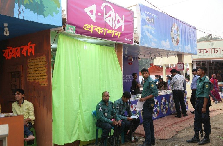BOOK FAIR. Bangladesh police personnel stand guard at publisher Shamsuzzoha Manik's stall at a book fair in Dhaka on February 16, 2016. File photo by AFP. 