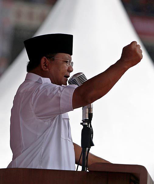 Prabowo Subianto makes fist as he shout slogans to supporters during a campaign at Bung Karno stadium in Jakarta. Photo by Adi Weda/EPA