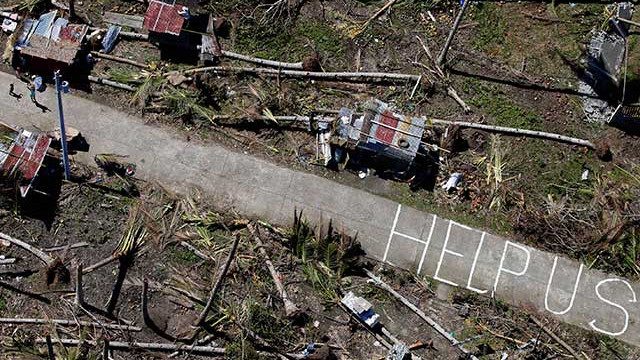 HUMANITY'S FUTURE. A community ravaged by Typhoon Haiyan writes a message for humanity 
