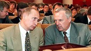GOING UP THE RANKS. Vladimir Putin (L) in the late 1990s. Photo from Putin's biography  