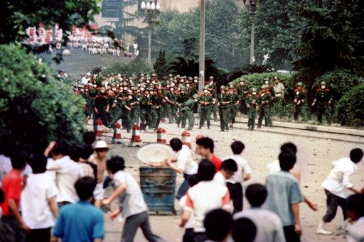 CLASHES. Chinese citizens and students of Chengdu, capital of Sichuan province, hurl stones at troop on June 4, 1989 during a rioting following the proclamation of the martial in the city. File photo by AFP 