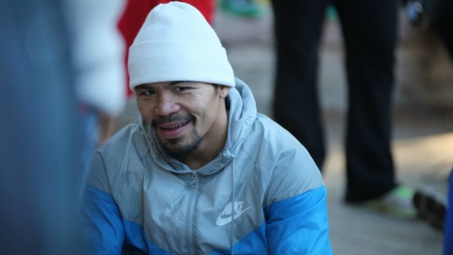 Manny Pacquiao affects a slight smile after his workout