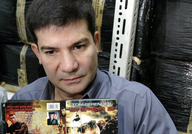 CONFISCATION. Edu Manzano shows copies of pirated DVDs seized and impounded at an airport cargo terminal. File photo by Rolex dela Peña/EPA  