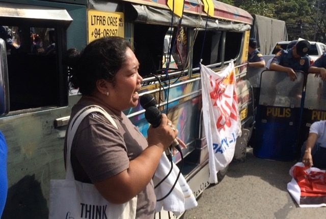 SEEKING AID. Housewife and urban poor leader Stella Poblete airs her community's plight in a rally in front of the National Housing Authority. Photo by Patty Pasion/Rappler 
