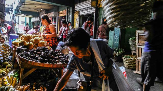 MARKETPLACE. Locals pick out fruits at a market in Cebu. Photo by Hannah Reyes  