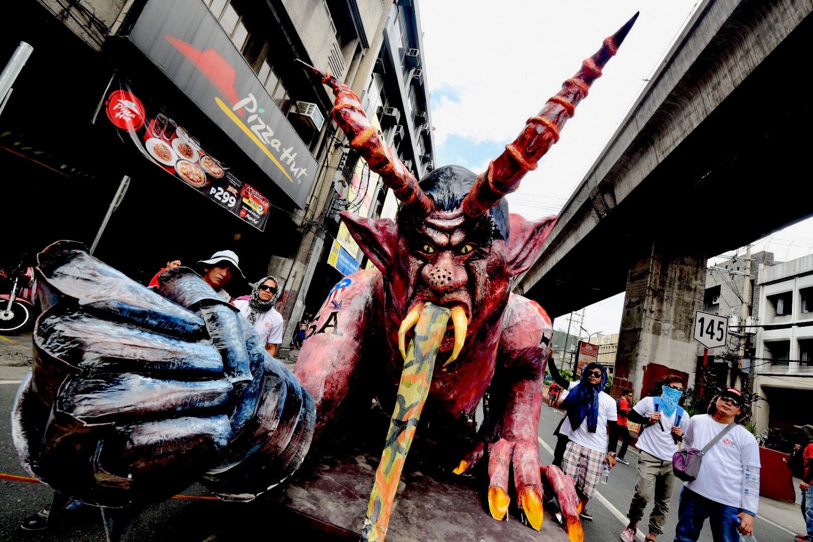 BURN. Called "Dutertemonyo," an effigy depicting the face of Duterte as a demon was later burned during the demonstration. Photo by Alecs Ongcal/Rappler 