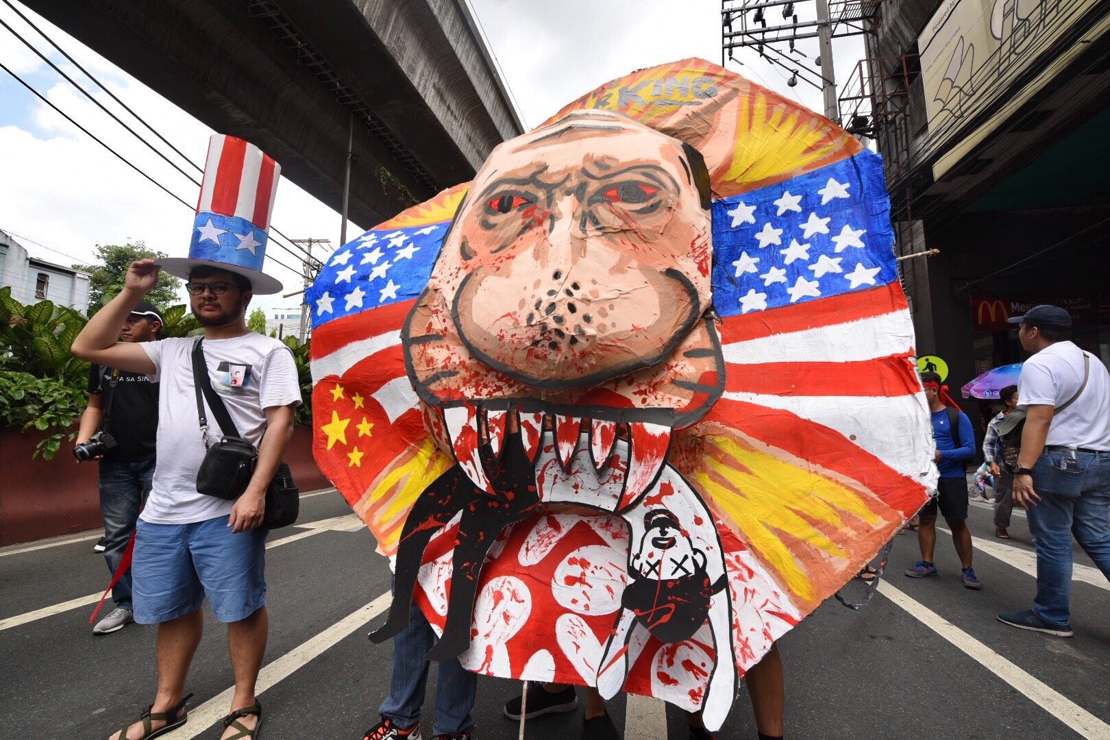 EFFIGY. On the way to Mendiola, an effigy depicting Duterte eating a Filipino is being pushed by protesters during the rally. Photo by Alecs Ongcal/Rappler  