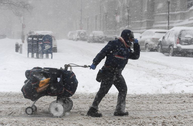 BOMB CYCLONE. A mail delivery person pulls a cart through the snow in Brooklyn, New York,  on January 4, 2018, as a giant winter 'bomb cyclone' walloped the US East Coast with freezing cold and heavy snow, forcing thousands of flight cancellations and widespread school closures.  Photo by Angela Weiss/AFP   