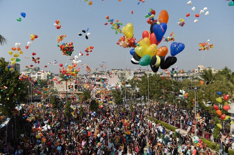 AFTER PRAYERS. Indian Christians release balloons as they welcome the new year in Ahmedabad on January 1, 2018. Photo by Sam Panthaky/AFP   