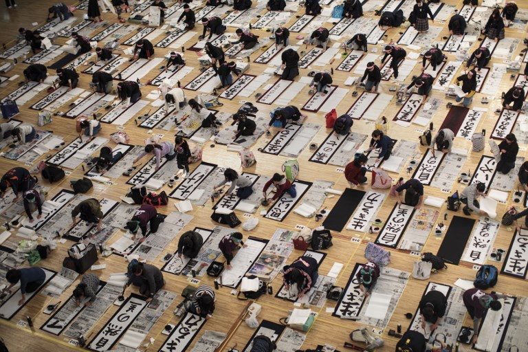 CONTEST. Participants write Japanese calligraphy during the annual New Year calligraphy contest in Tokyo on January 5, 2018. Photo by Behrouz Mehri/AFP  