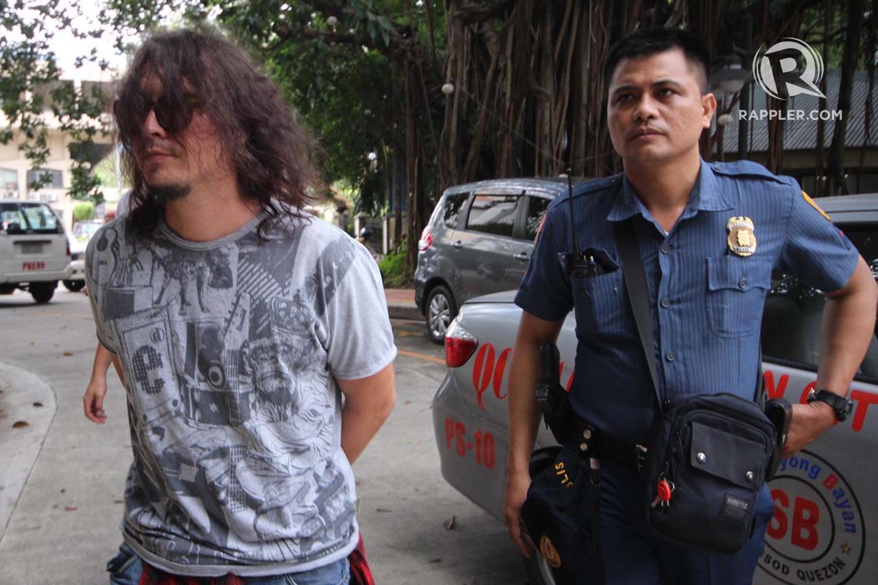Baron Geisler is escorted by a policeman for inquest at the Quezon City fiscal office on Tuesday, after he was arrested on Monday night, by members of the Quezon City Police District's Station 10 along Kamuning Road. Photo by Darren Langit/Rappler 