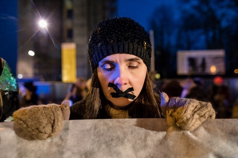 PRO-ABORTION. A protester tapes her lips during an anti-government demonstration on January 10, 2018, outside the Parliament in Warsaw, Poland. The parliament, which is controlled by the conservative Law and Justice party, is due to begin discussing two competing draft laws: one that aims to liberalize the law and another that seeks to ban abortion when the fetus is deformed. Photo by Wojtek Radwanski/AFP   