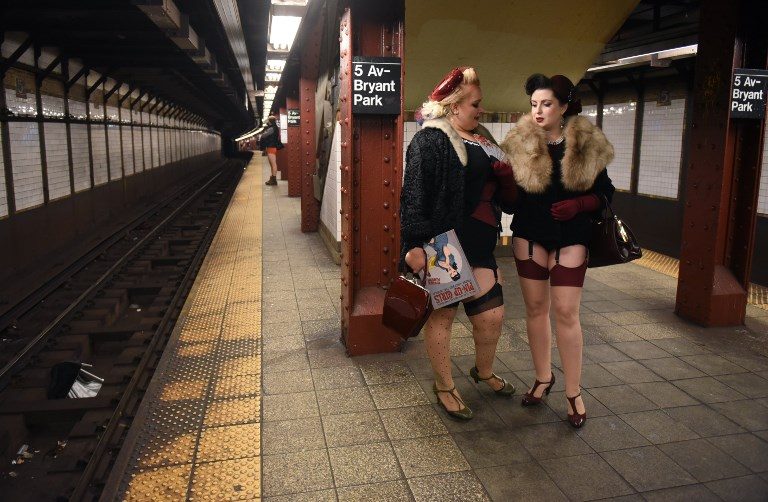 17TH YEAR. Participants in the annual 'No Pants Subway Ride' wait for a New York train on January 7, 2018. The event, which started in 2002, urges subway riders to dress in normal winter clothes without pants while keeping a straight face. Photo by Timothy Clary/AFP   