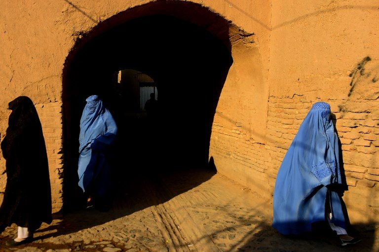ON THE DECLINE. Burqa-clad women walk in the old part of Herat, Afghanistan, on January 9, 2018. The wearing of the burqa or chadri was a rarity until the Taliban took power and required all women to wear them in public. The current regime has dropped the requirement but local feudal lords still enforce it particularly in southern region. Photo by Hoshang Hashimi/AFP    
