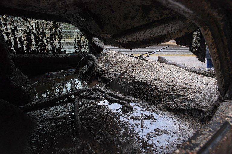 DISASTER. Mud fills the interior of a car destroyed in a rain-driven mudslide in a neighborhood under mandatory evacuation in Burbank, California, on January 9, 2018. Photo by Robyn Beck/AFP   