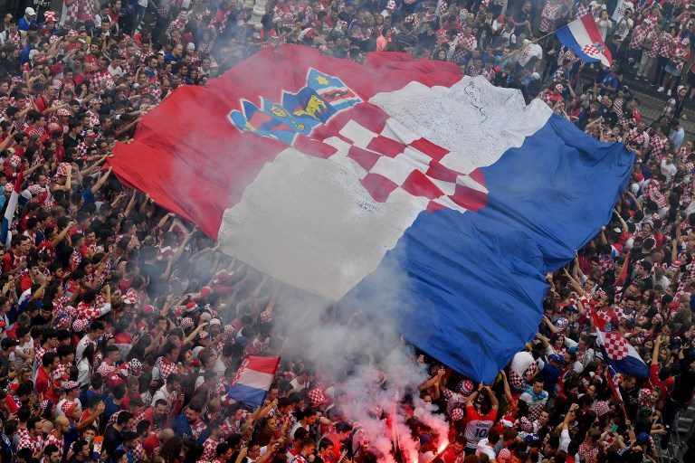 HISTORIC. Supporters hold a huge Croatian flag in downtown Zagreb as they gather to watch their country's first ever World Cup final appearance. Photo by Andrej Isakovic/AFP   