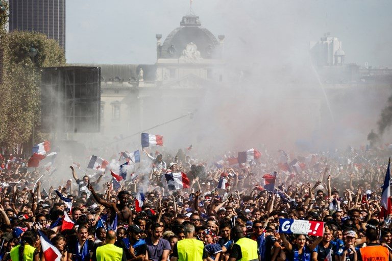 1-0. People celebrate France's first goal as they gather on a fan zone at Champ de Mars in Paris. Photo by Charly Triballeau/AFP   
